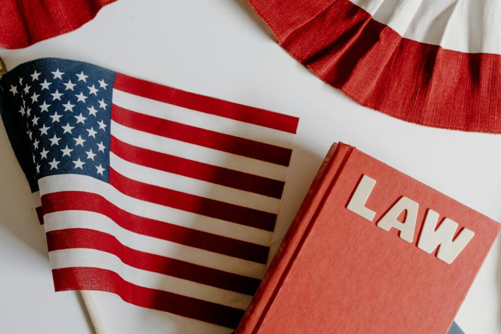 american flag beside a law book on white background
